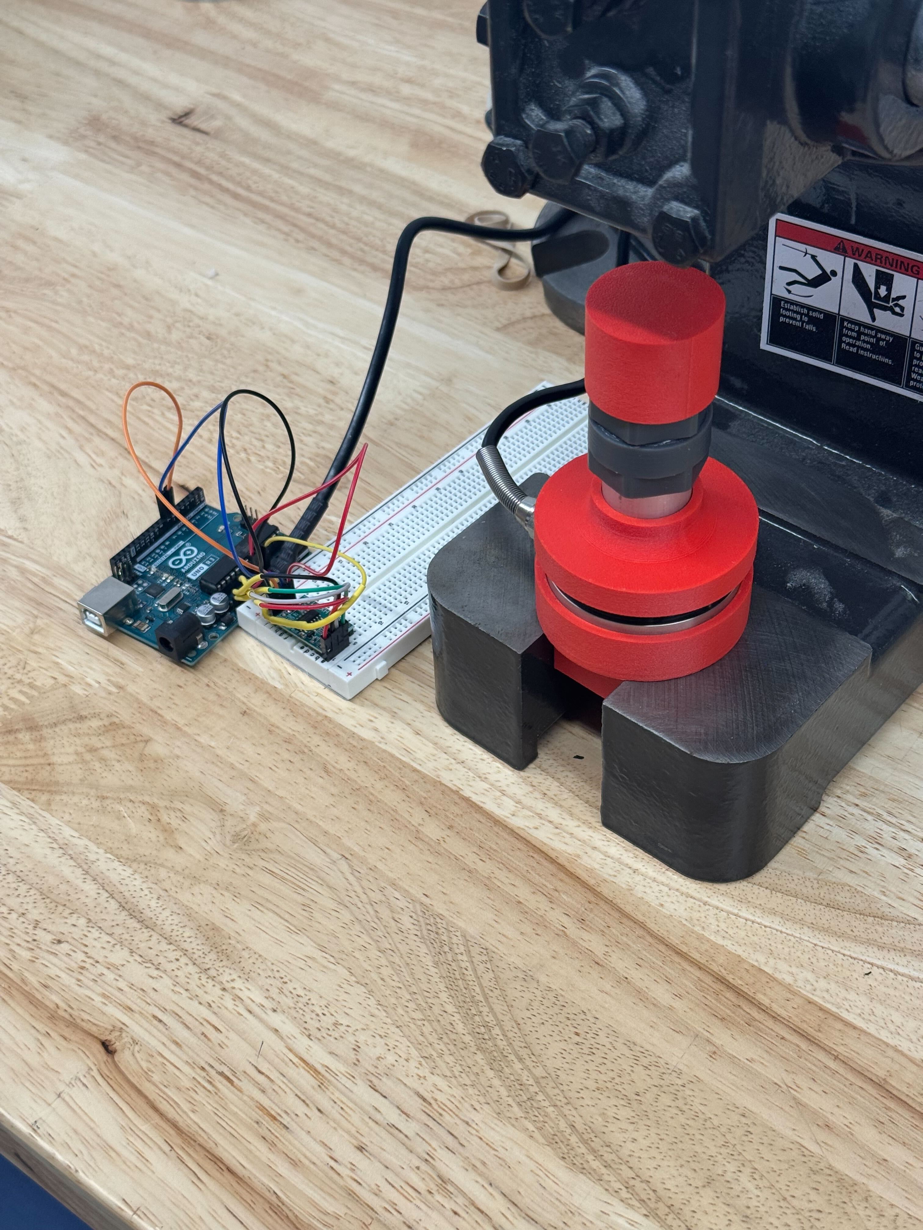 Test fixture set up in the arbor press with the load cell electronics
